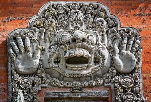 Picture of carvings depicting demons or gods above the entrance to the temp